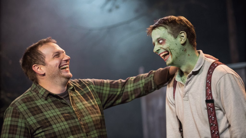 Man laughing and putting his hand on a friendly zombie's shoulder, showing zombies are not real, with dark background